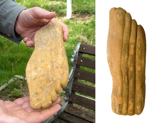 Una escultura de tamaño natural de piedra arenisca de un pie humano